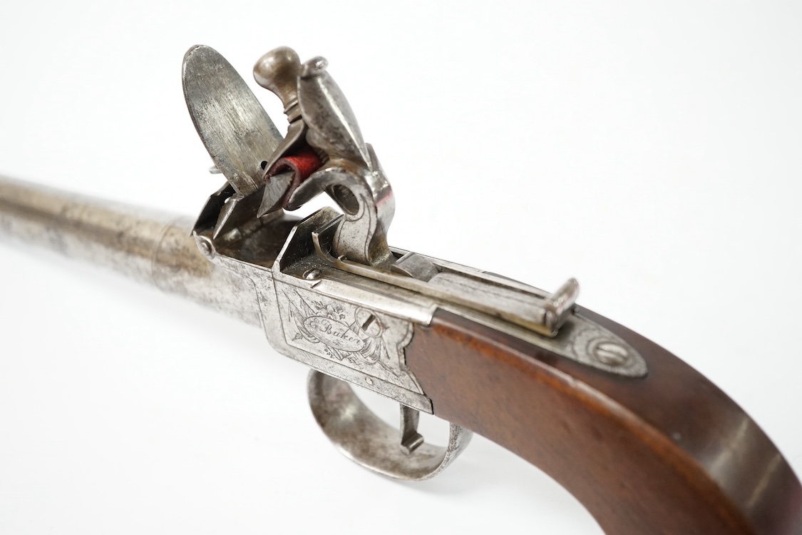 A 16 bore boxlock flintlock overcoat pistol by Ezekiel Baker, with turn off barrel, 11.5cm, London proved, frame signed within ovals upon flag trophies, sliding top thumb safety locks frizzen fence, slab walnut grip, 27c